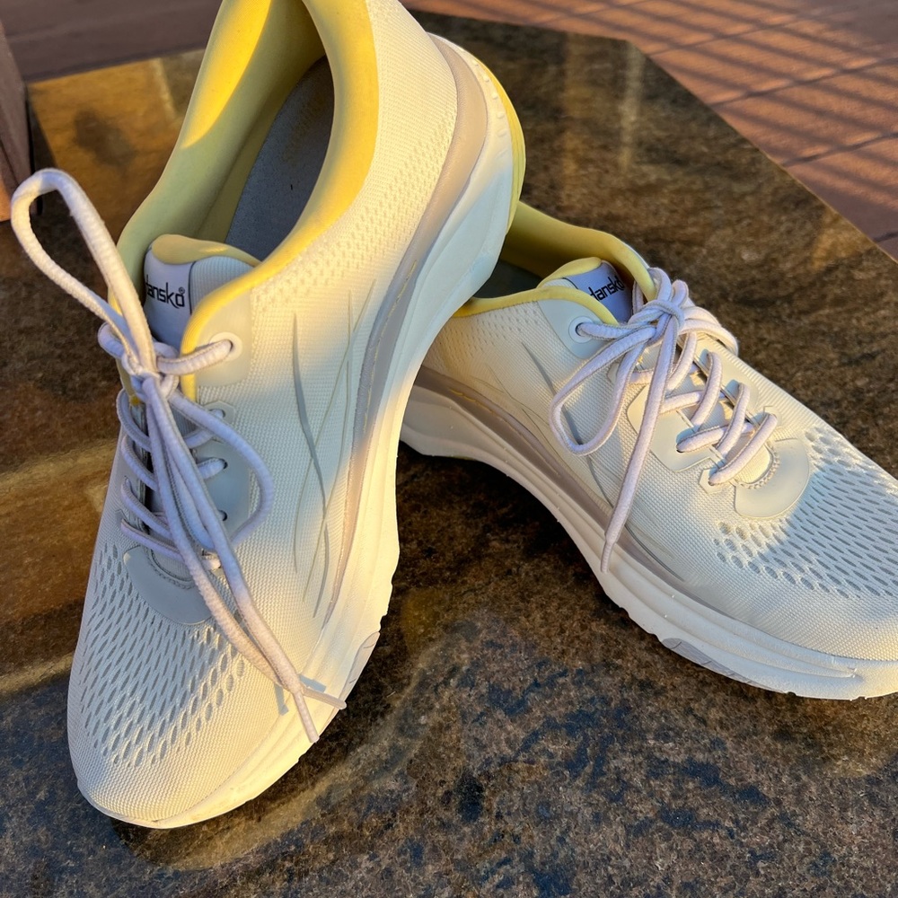 Dansko Women's White Sneakers with yellow accents.